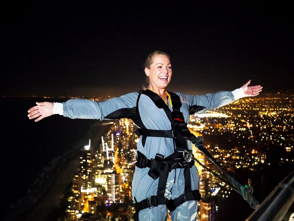 Climber doing the lean back at night