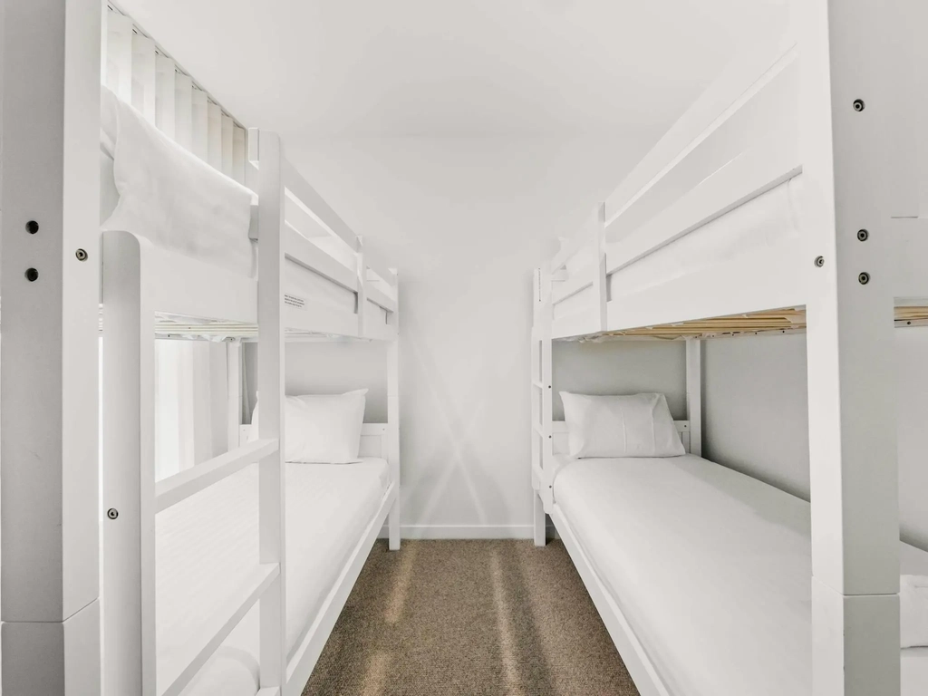 Bunk room with two sets of timber bunk beds sleeping four.