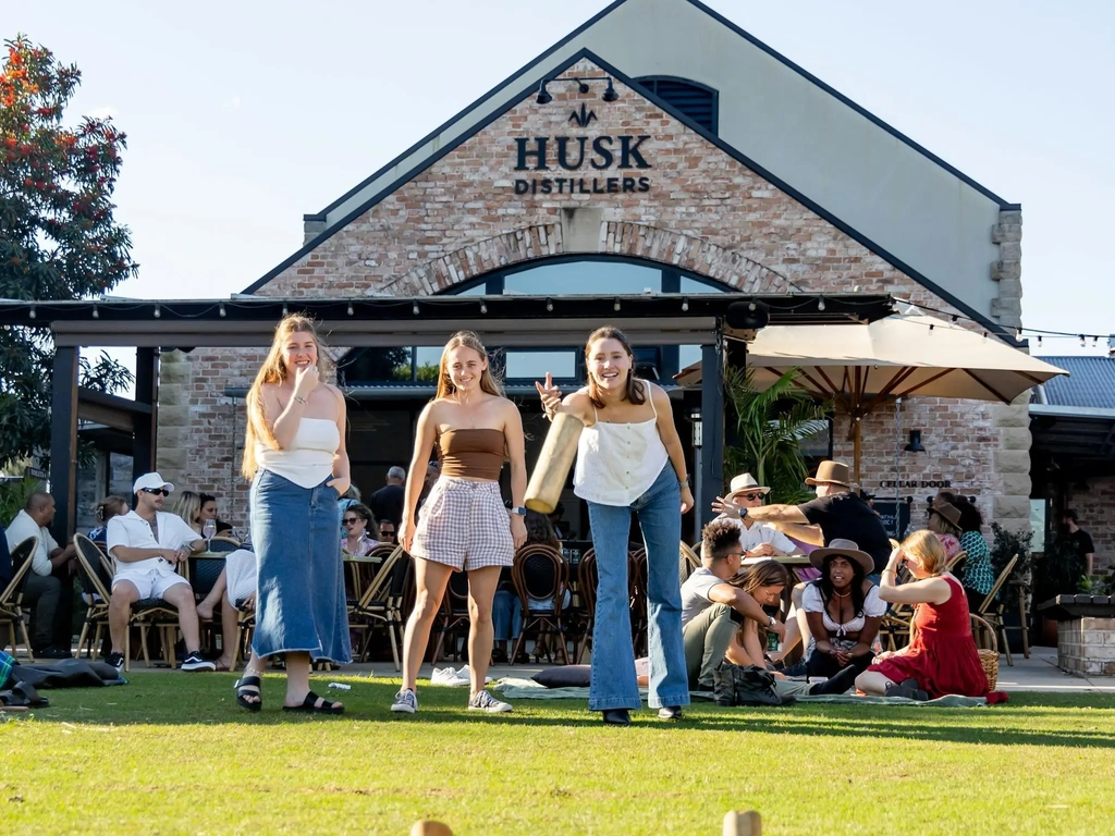 Guests playing lawn games at Husk Farm Distillery.