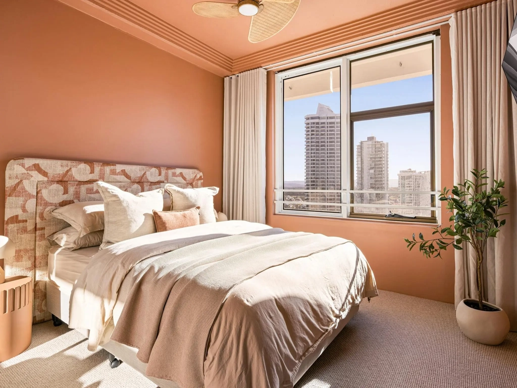 Second bedroom with a queen bed, patterned headboard and a city outlook