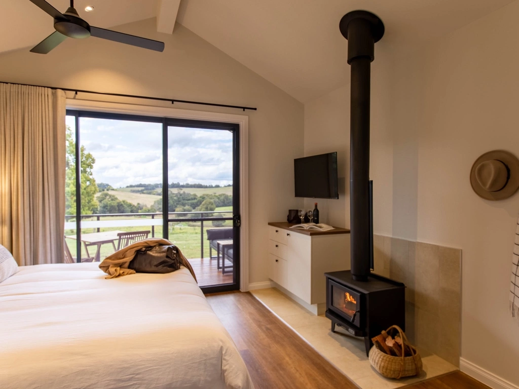 Interior of King Farm cabin at Hazelwood with fireplace and views of rolling hills