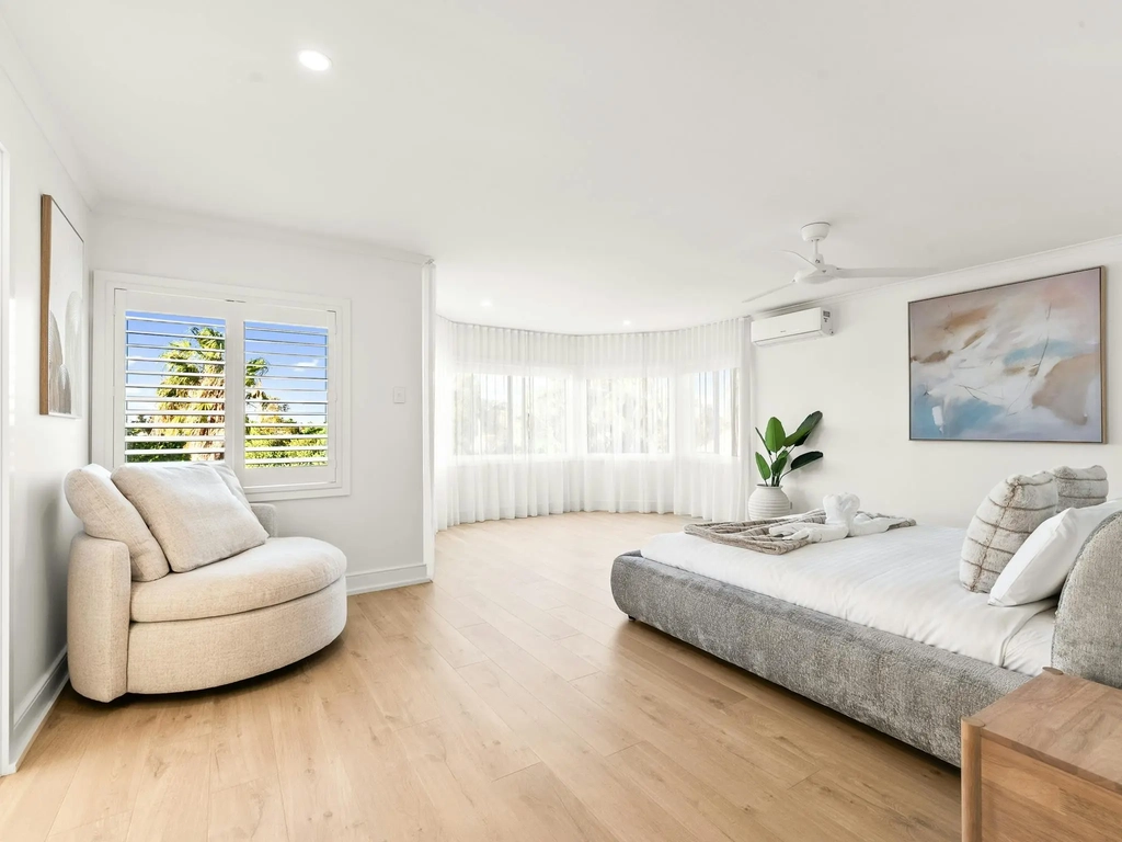 Master bedroom with a bay window and sitting area