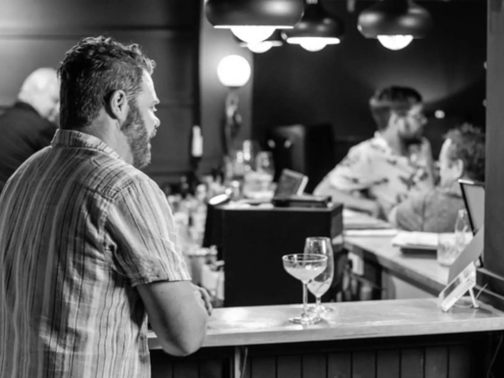 A gentleman enjoying a quiet beer at the bar