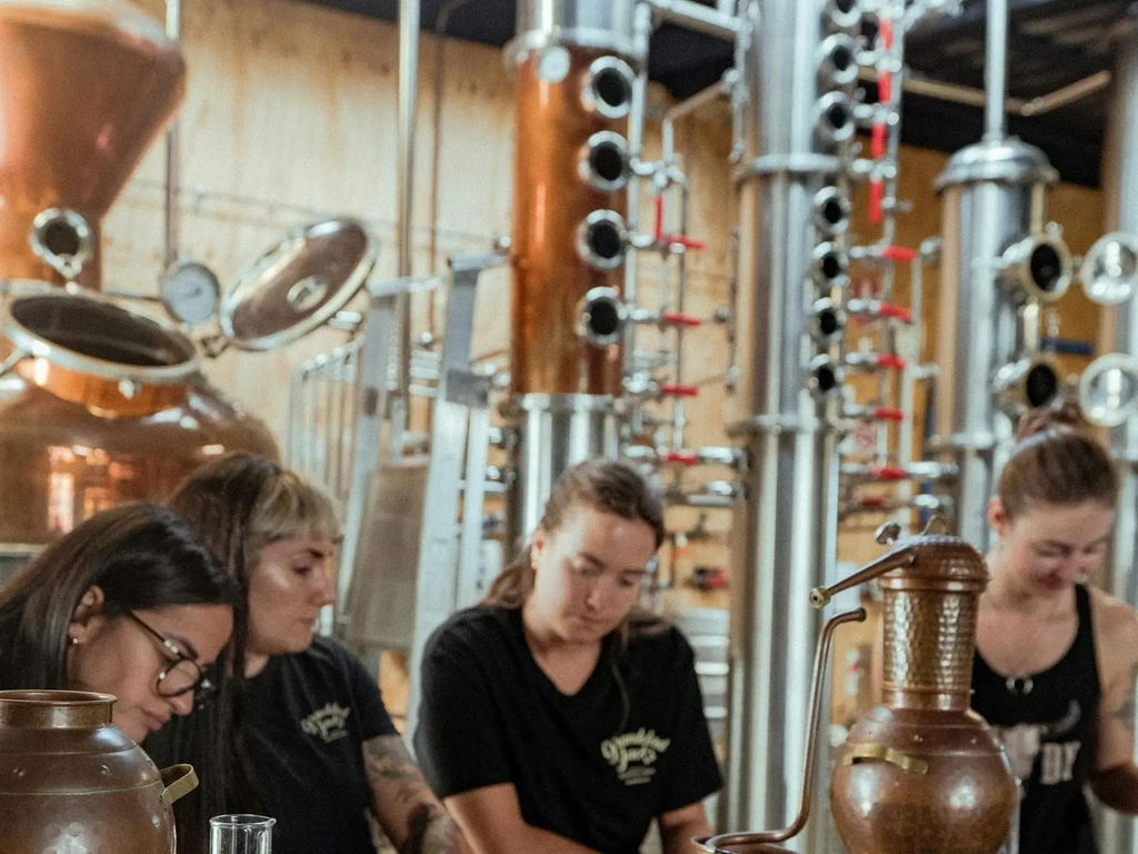 Mica teaching the bar staff about distilling.