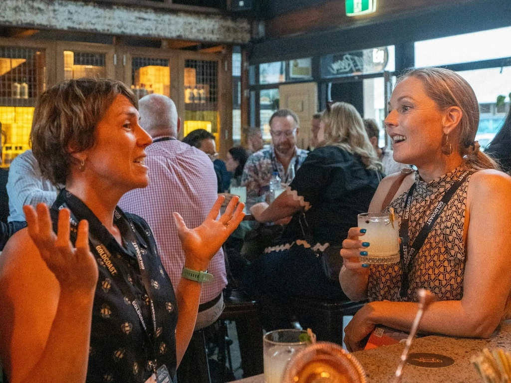 Two customers enjoying a drink and a chat at the bar of Granddad Jack's Craft Distillery