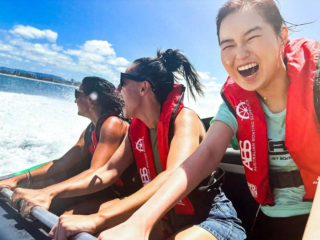 3 ladies wearing life jackets and smiling on Arro Jet Boat.