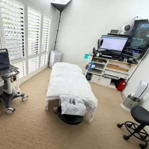 Heal Young Massage treatment room with massage table and diagnostic ultrasound on Gold Coast.