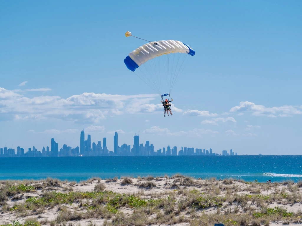 Tandem landing with city skyline