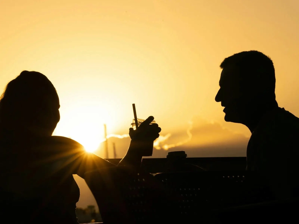 Harley and Hudson Coffee Bar customers drinking coffee during sunrise