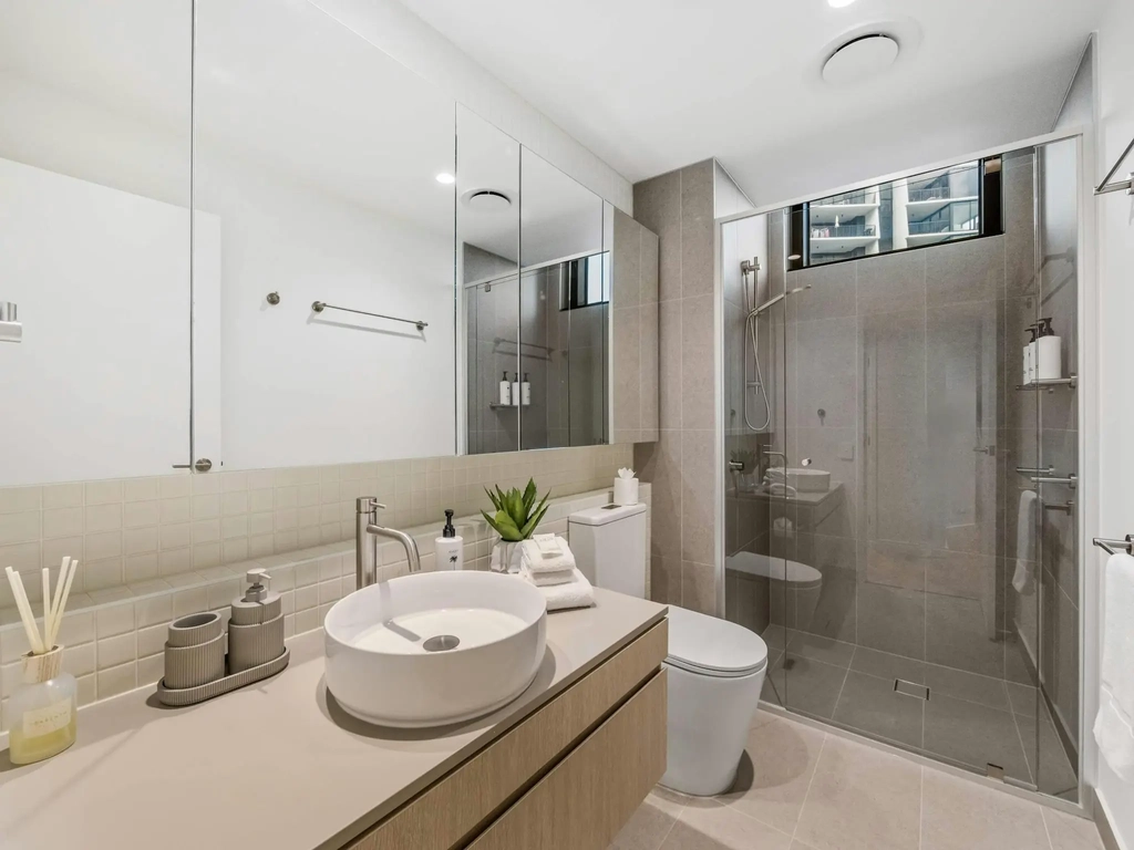 Second bathroom with a vanity, a toilet and a glass walk in shower.