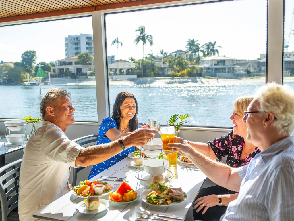 Group of friends cheersing inside a boat