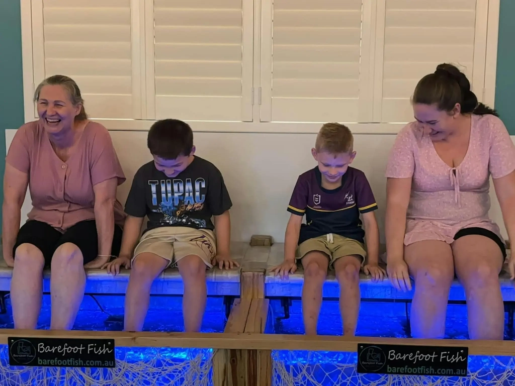 A Family enjoying a Fish Spa at Barefoot Fish