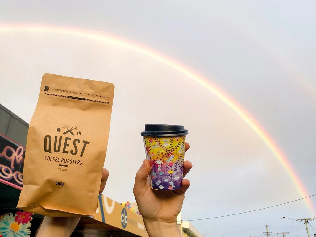 Organic roasted coffee beans and barista made artisan coffee available. Photographed under a rainbow