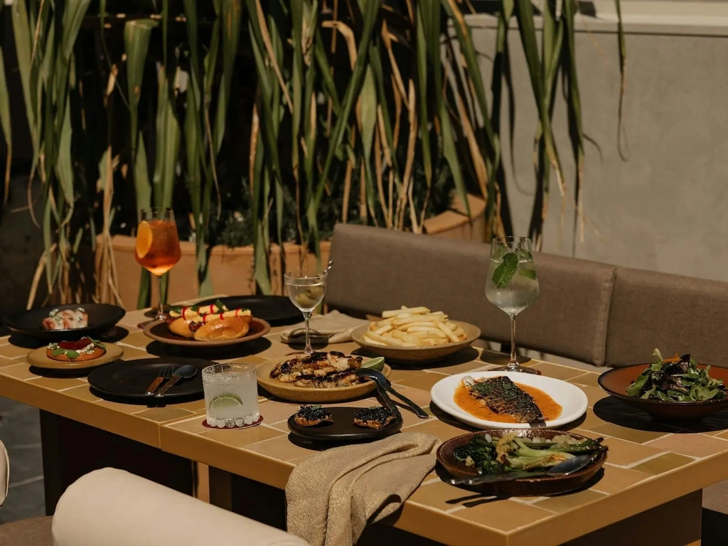 Norte patio with a table full of food and drinks