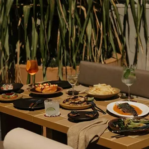 Norte patio with a table full of food and drinks