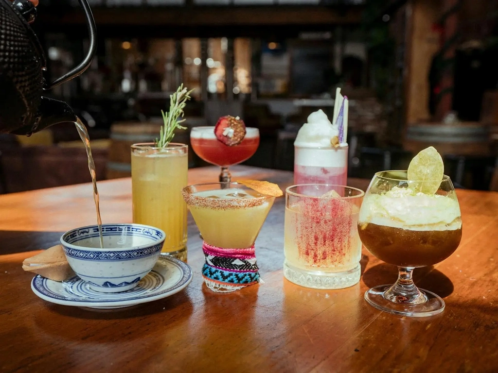 A picture of 7 cocktails sitting on a table