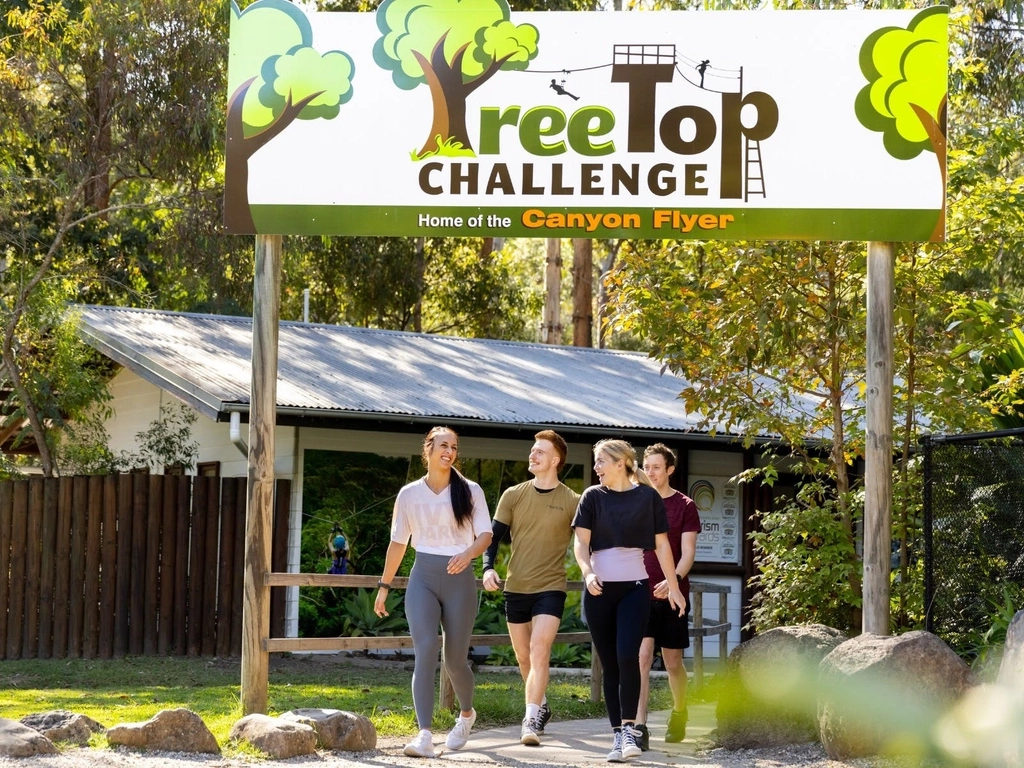 TreeTop Challenge building with smiling guests leaving
