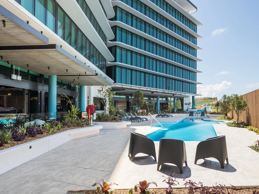 Enjoy a drink poolside at Rydges Gold Coast Airport