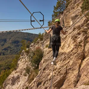 Woman walking across Via Ferrata at Happitat Adventure Park