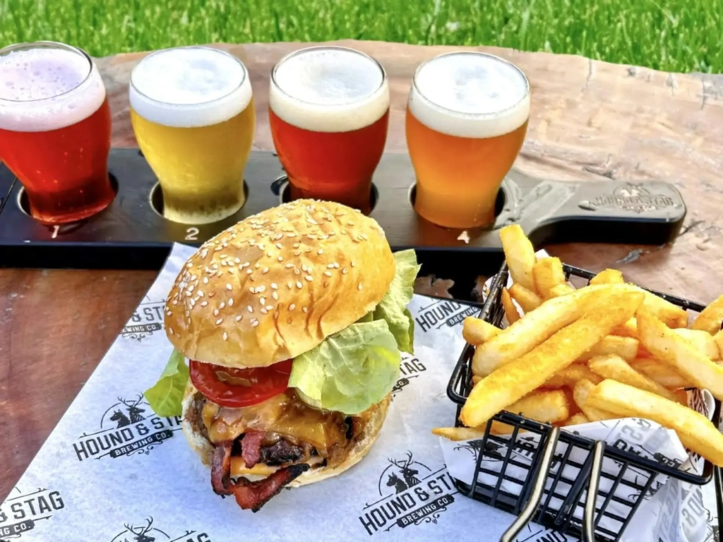 Hound Beef Burger with fries and beer paddle