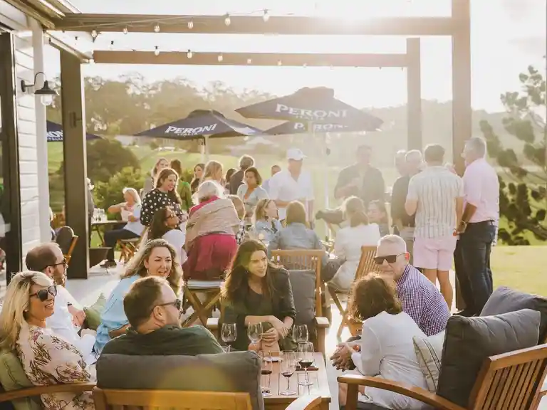 Guests enjoying a drink on The Paddock restaurant's Sunset Terrace