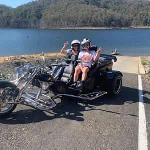 Image shows a boom mustang trike parked near the waterfront of Hinze Dam.