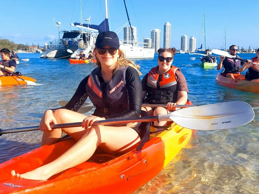 Guest sitting in a red kayak before launching into the Gold Coast Broadwater near Wave Break Island