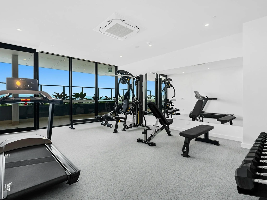 State-of-the-art fitness center with modern equipment, ideal for workouts with a view of the Gold Co