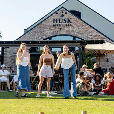 Guests playing lawn games at Husk Farm Distillery.