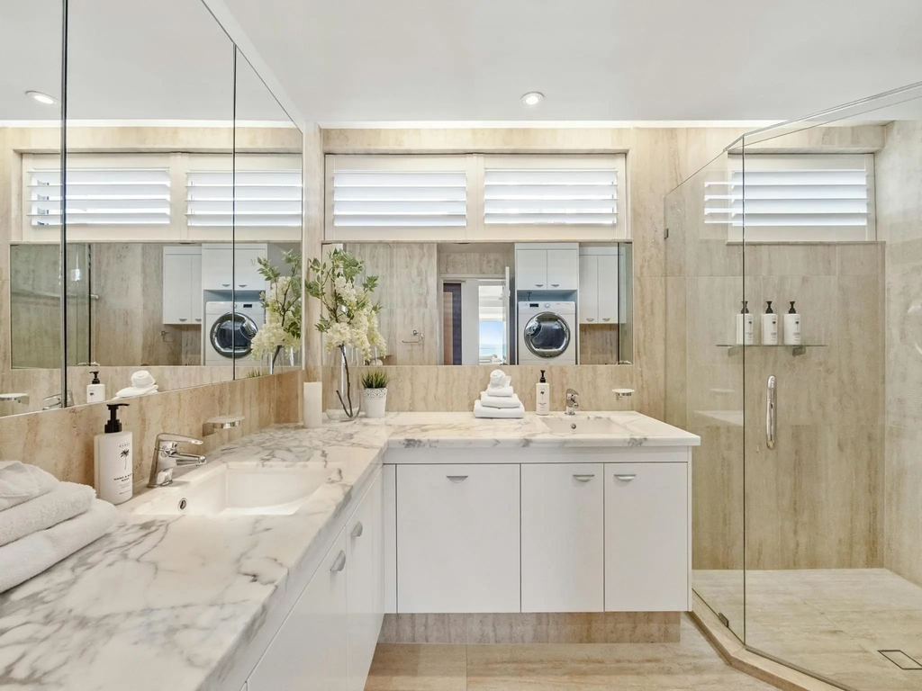 Bathroom with twin marble vanity and walk-in shower