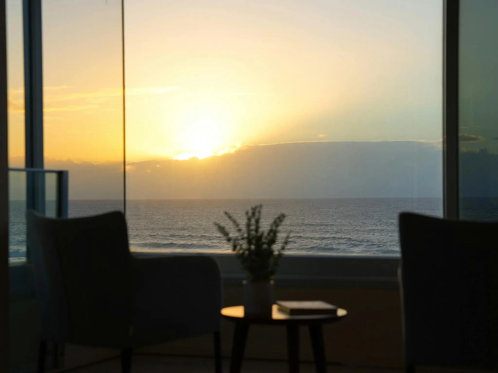 Sunrise over the ocean seen from the beachfront apartment living room