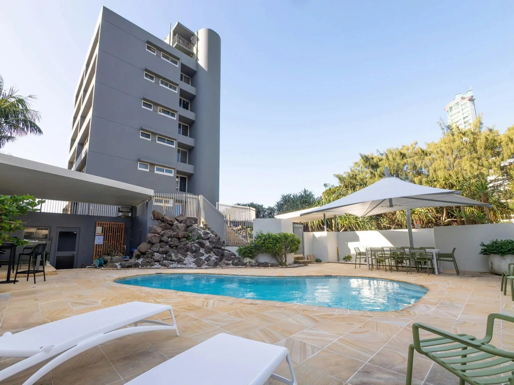 Ground-level swimming pool and garden at the building