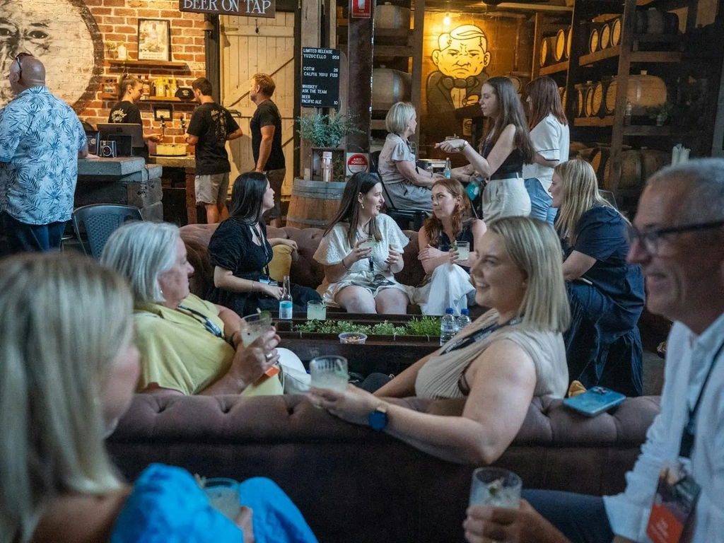 Customers chatting and drinking at Granddad Jack's Craft Distillery