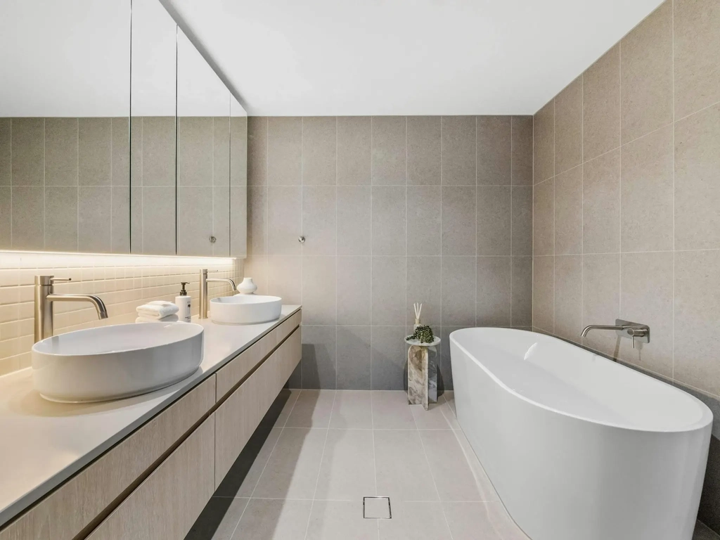 Main bathroom with twin basins, a freestanding bath and a walk in shower.