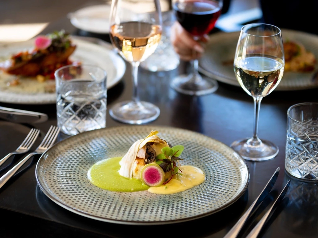 Selection of wood-fire dishes from The Fireplace with glasses of wine