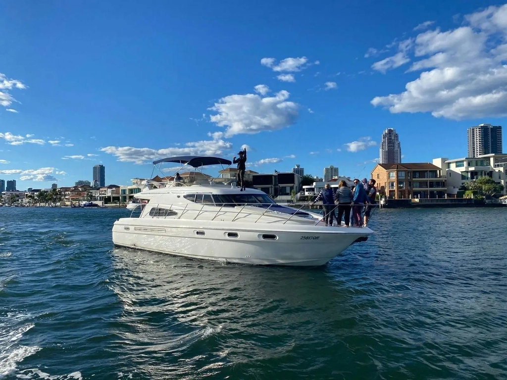 White luxury motor yacht cruising the Broadwater on a sunny day in Gold Coast