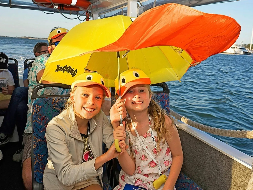 Children holding Quack'R'Duck Merch Unmbrella