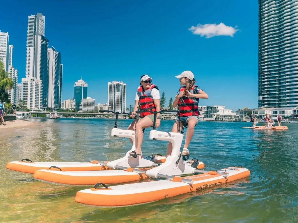 Mother and daughter riding double waterbike in Surfers Paradise
