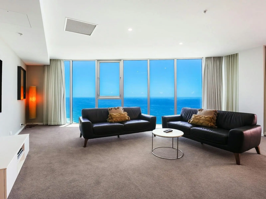 Spacious lounge room with ocean view background at the Hilton Surfers Paradise - Gold Coast Holidays