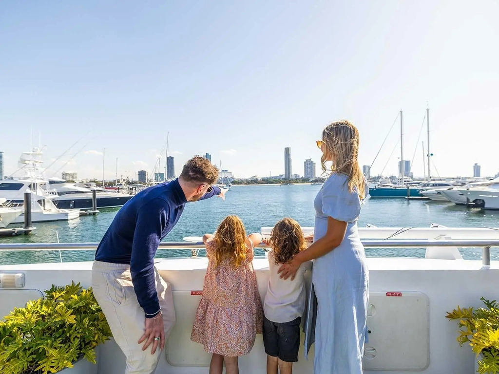 A mother and father with their two young children  on a boat