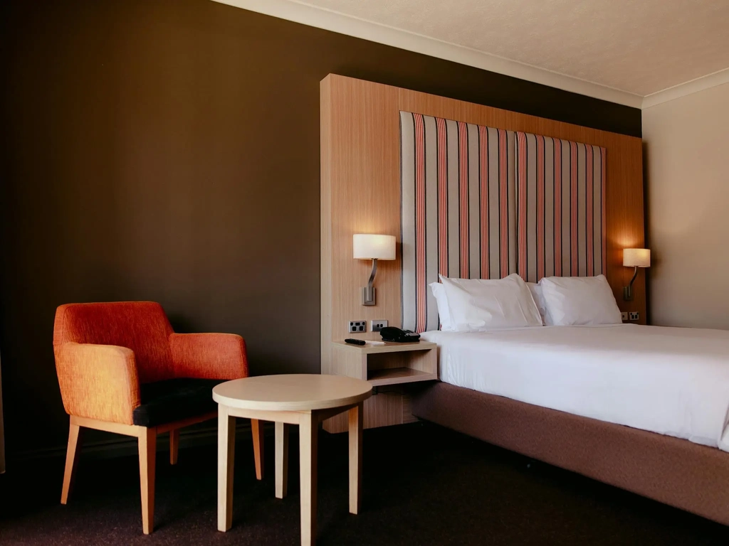 King bed room with chair seating area