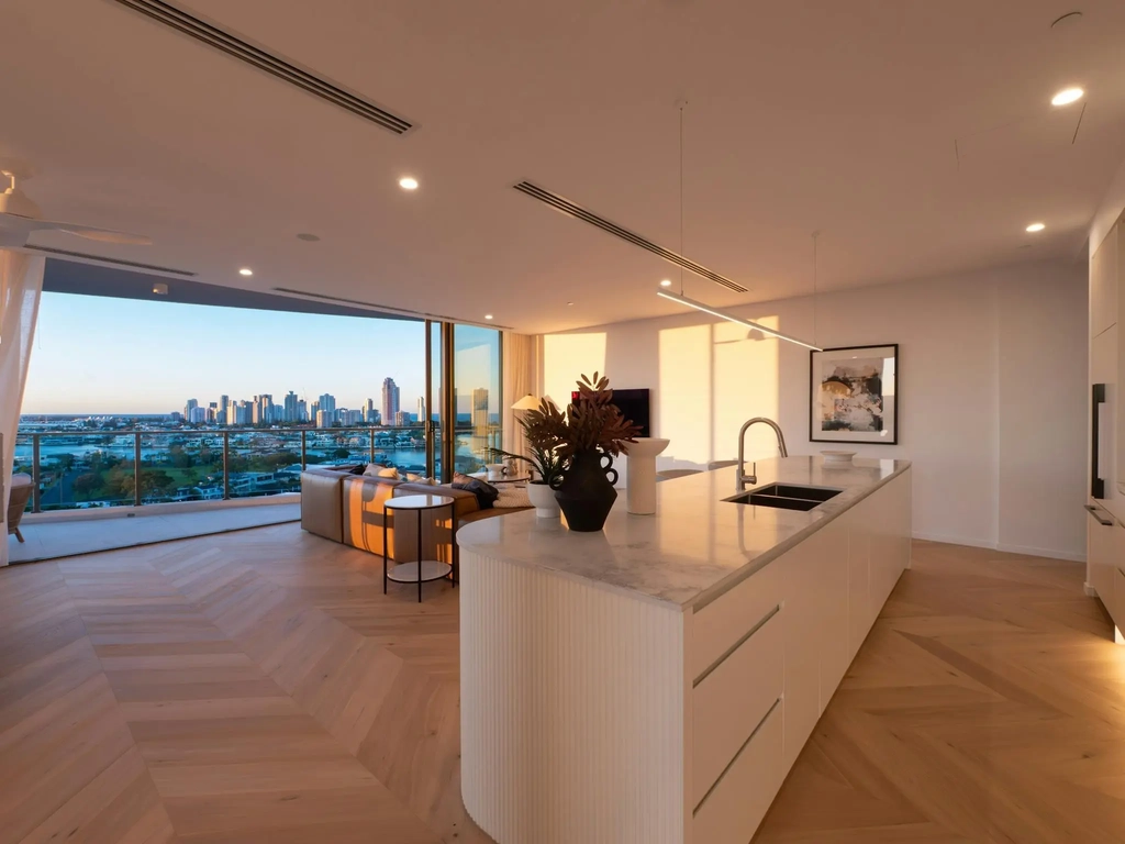 Living area at dusk with the Surfers Paradise skyline through full-height glass