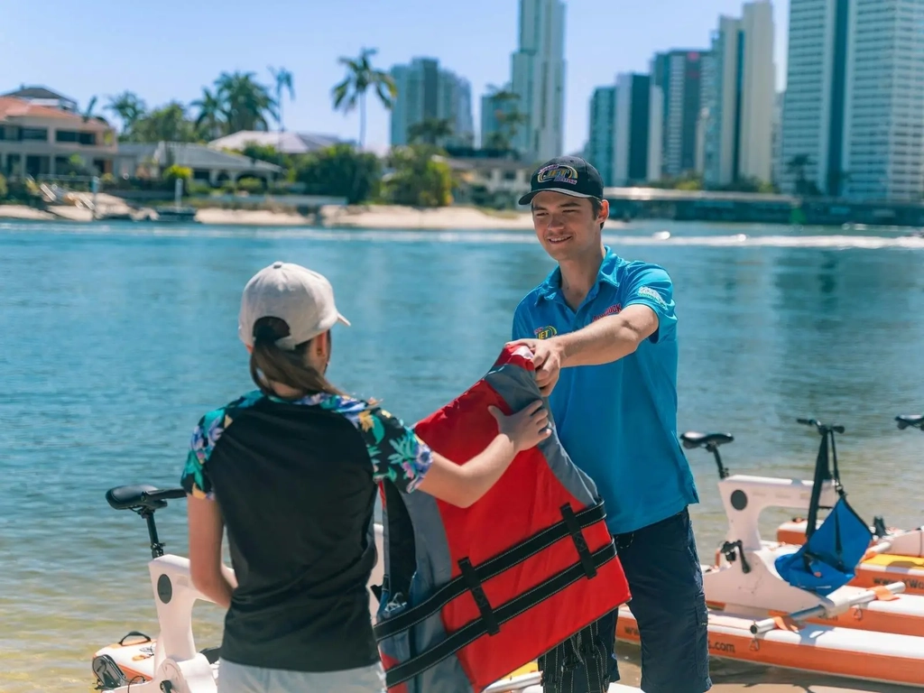 Paradise Waterbikes Crew member handing out life jackets
