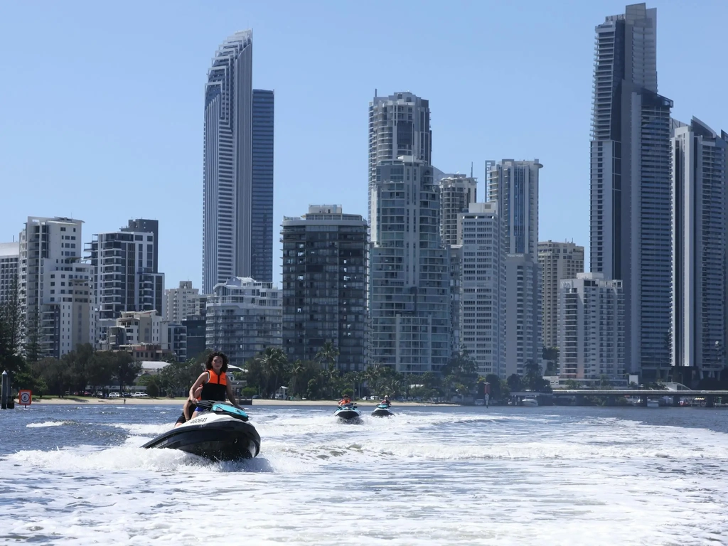 Tour group passing Sufers Paradise on their Jetskis