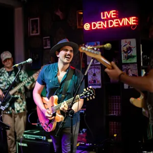 Den Devine's electrifying stage sets the scene for legendary live music, rocking 6 nights a week