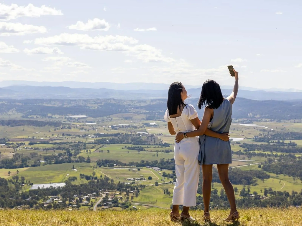 Two ladies taking photos at scenic lookout