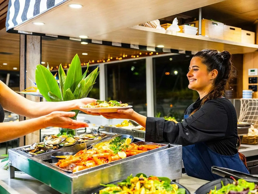 Friendly crew serving Buffet Dinner