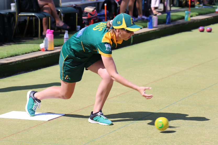 Woman playing lawn bowls