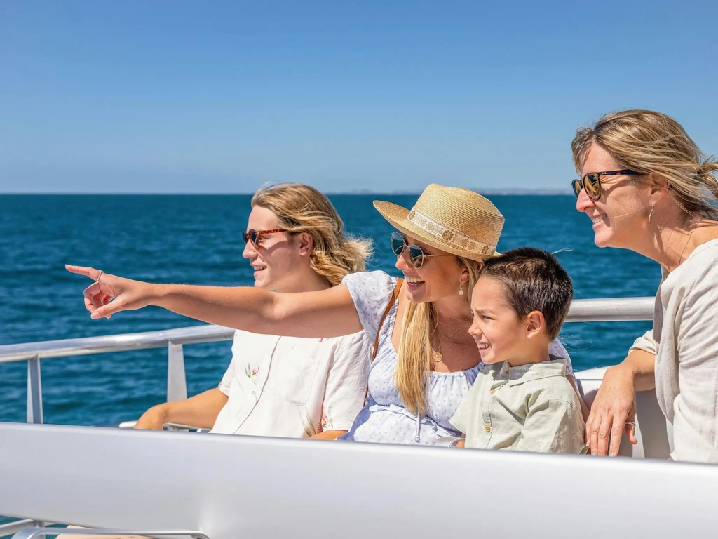 Family pointing at whale