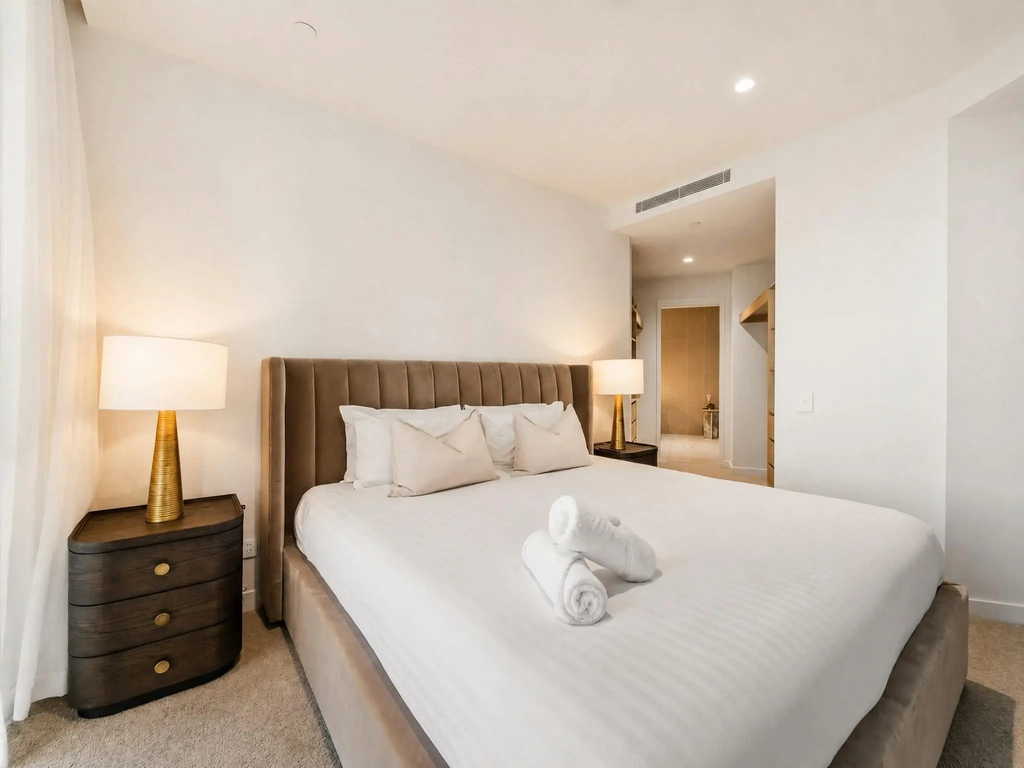 Main bedroom with a king bed and a walk in robe leading through to the ensuite.